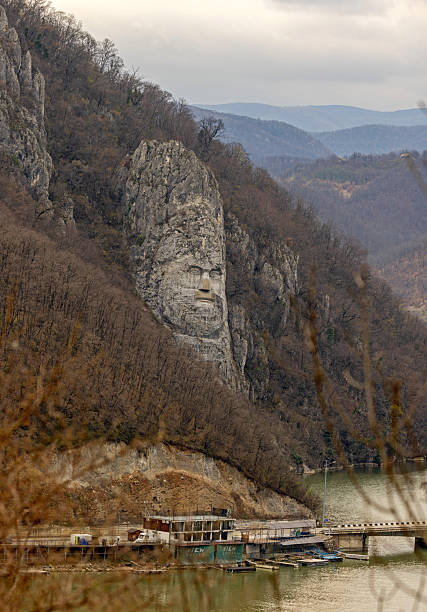 Dubova, Romania - March 14, 2024: Rock Sculpture of King Decebalus of Dacia Colossal Face Carving in Stone at Danube River Gorge.