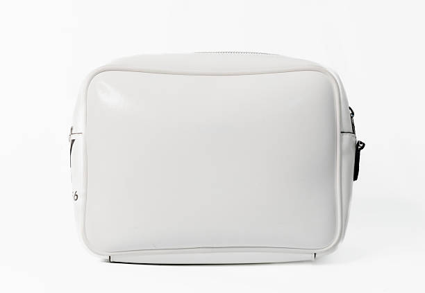 Minimalist luxury white leather crossbody bag isolated on a clean white background featuring a compact rectangular design with adjustable shoulder strap and zipper closure photographed in a professional studio shot with copy space suitable for e-commerce fashion catalogues and retail marketing