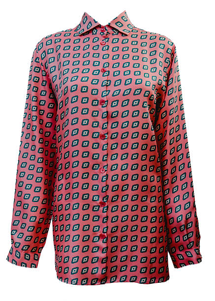 Front view of a stylish long-sleeve women's blouse featuring a vibrant pink base with a repetitive geometric square pattern in teal and black. Elegant button-down shirt with a classic collar, perfect for professional or casual chic wear. High-quality fashion apparel studio shot isolated on a white background.