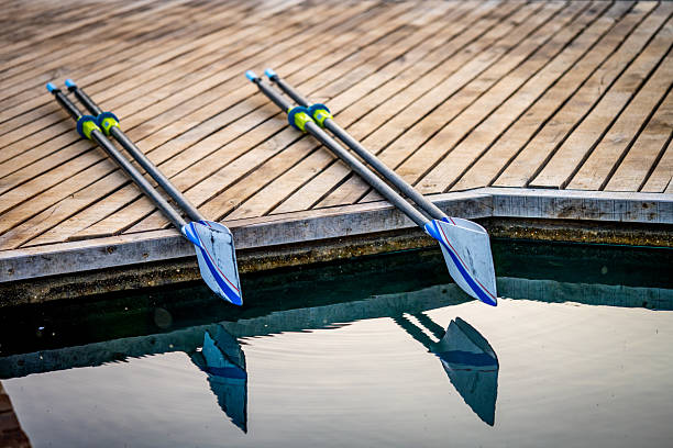 Cambridge, Massachusetts, USA -  May 22, 2024: Close-up of a woman rower in a single sculling boat on the Charles River.
