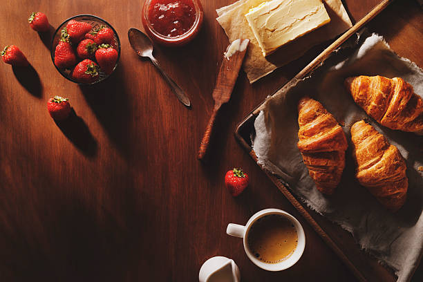 Cozy morning breakfast  with croissant, butter and fresh strawberries.