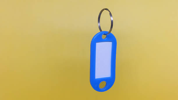 Plastic key card with tag on a gray background. Template for design
