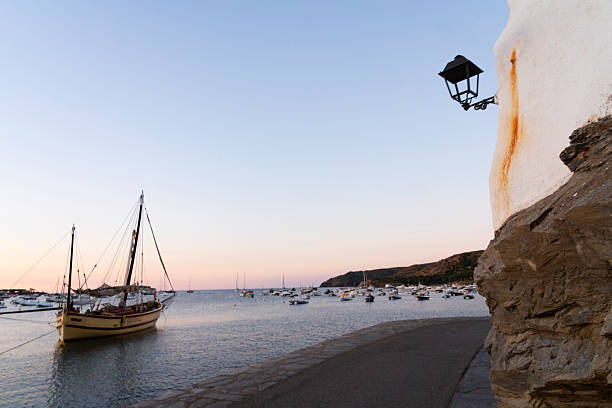 Sailboats in the tranquil Port d'Alguer in the small fishing village of Cadaques on the Costa Brava, Girona, Catalonia, Spain
