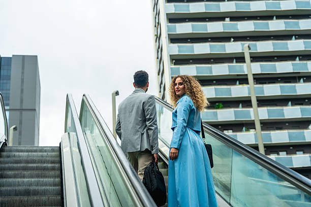 istock Successful business people commuting on urban escalator 2255340560