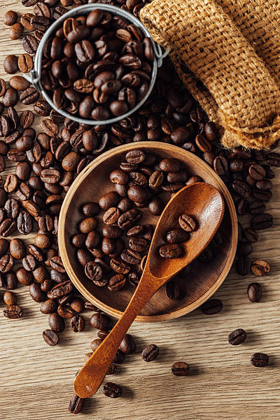 Top View of Roasted Coffee Beans with Wooden Spoon and Sack