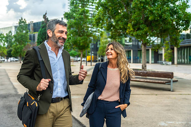 istock Business colleagues walking and talking in city district 2255340631