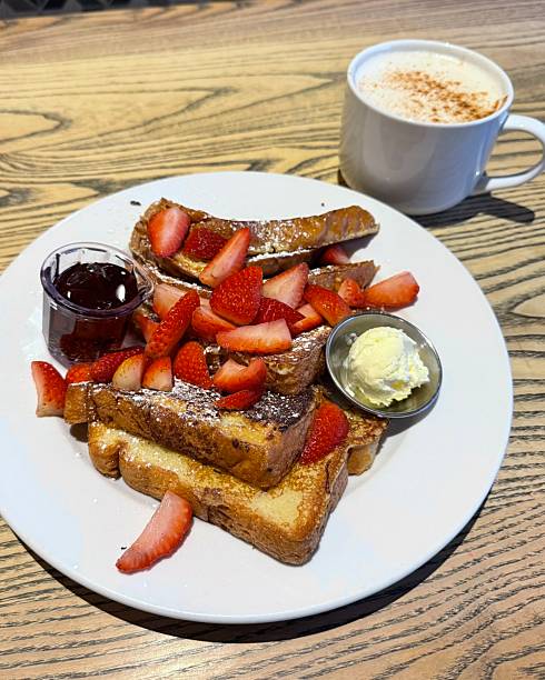 Golden French toast topped with fresh strawberries, offering a soft, custardy texture and gentle sweetness. Warm, inviting, and visually appealing, perfect for cozy breakfast or brunch moments.