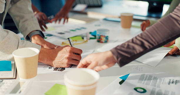 istock Business people, hands and meeting with documents for planning or project brainstorming in office. Group, employees or designers with paperwork or ideas for tasks, agenda or campaign in workplace 2255347277