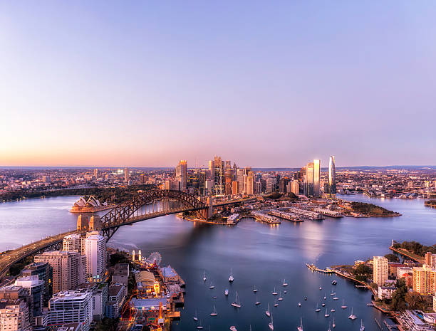 Sydney, Australia - 28 Jul 2025: Extra copy space in pink sky over Sydney harbour Lavender bay aerial view to city CBD at sunrise in Australia.