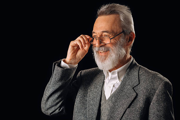 istock Senior man smiling, adjusting glasses, showing wisdom 2255351950