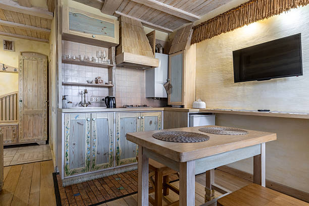 istock Rustic studio apartment interior with wooden kitchenette and dining area 2255354202