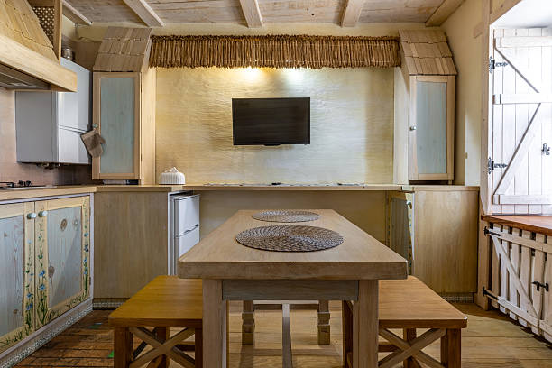 istock Dining area in rustic studio with house-shaped wooden cabinets 2255354232