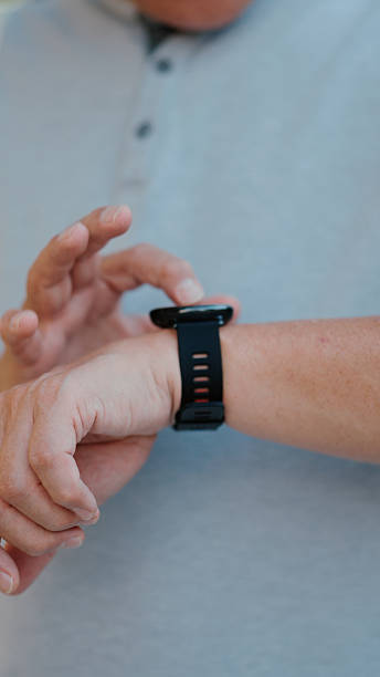 istock Senior man checking a smartwatch while exercising outdoors in a park 2255358610