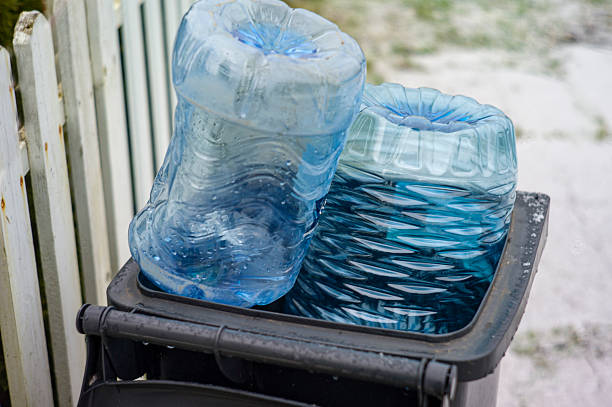 A recycling bin full of empty plastic water bottles.
