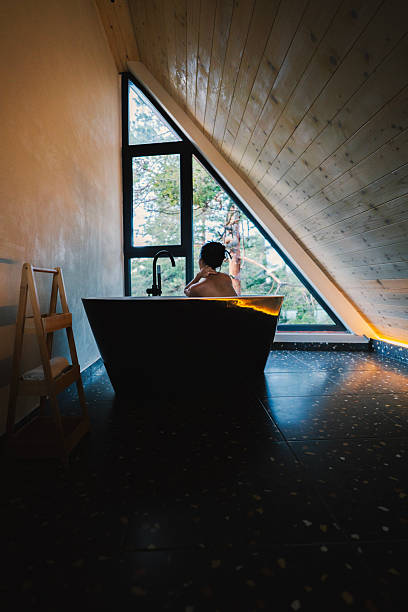 Modern bathroom with large bay window and view of sea