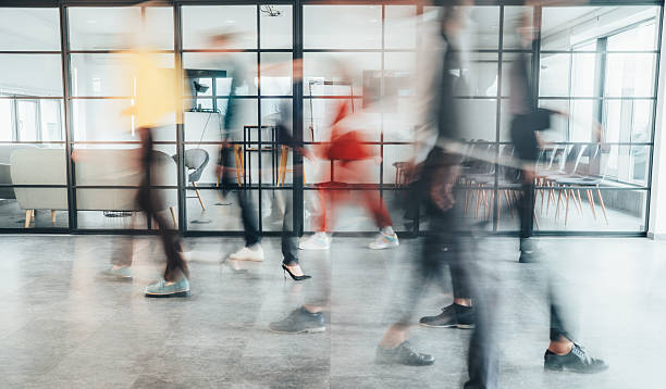 istock Blurred motion, group of people walking fast in the office lobby 2255369684