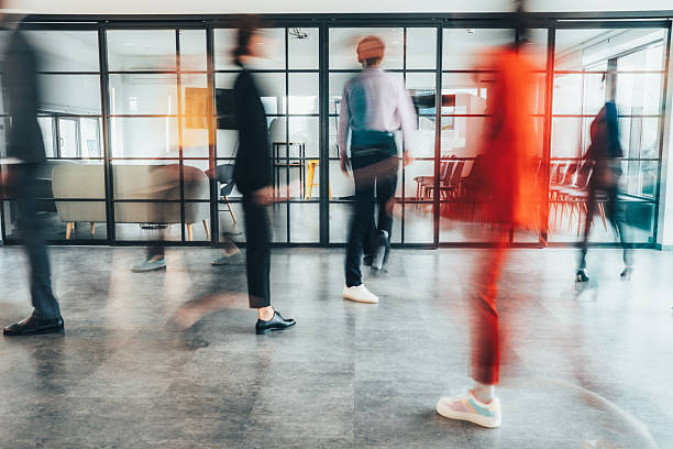istock Blurred motion, group of people walking fast in the office lobby 2255369685