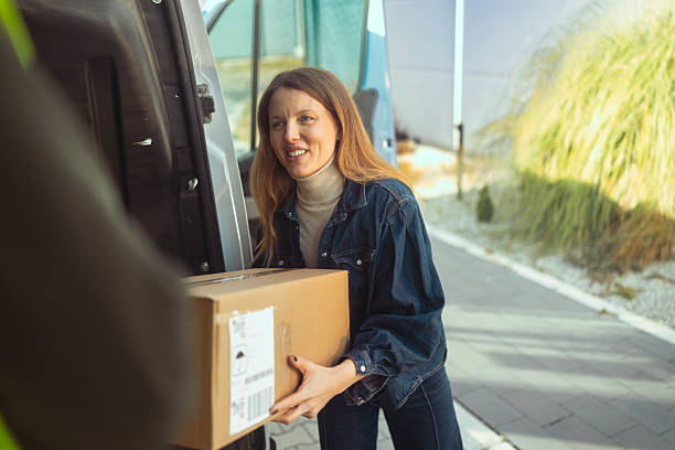 Happy Female Customer Receiving Large Parcel from Delivery Van Cargo Area