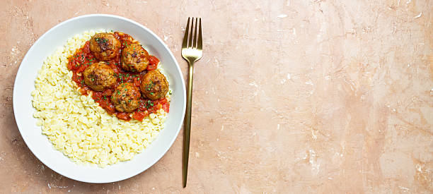 Pasta ptitim with meatballs in tomato sauce. Italian cuisine.
