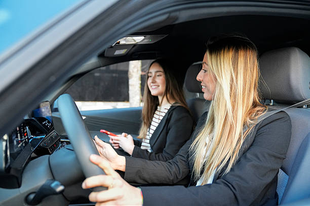 istock Women driving car laughing sharing travel experience 2255372699