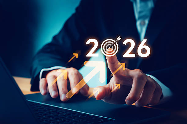 istock Business professional setting strategic goals for 2026, pointing at digital target icon with upward arrows, symbolizing growth, success, planning, performance, future business vision 2255373837