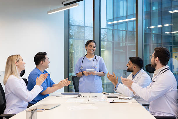istock A medical team celebrates a successful meeting in a modern office environment. 2255375086