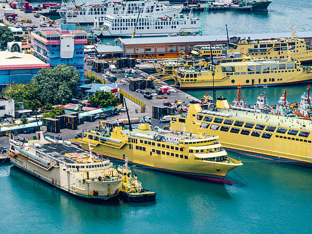 Colorful Cebu City port scene with bright yellow Cokaliong ferries, busy docks, and urban waterfront. Ships, cranes, and boats create a lively maritime hub along the Philippine coast.