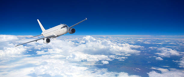 istock Commercial jet flying above fluffy white clouds 2255379865