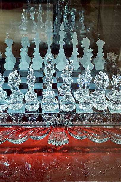 Luxurious crystal chess set with frosted and clear pieces arranged on checkered board.