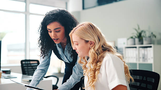 istock Business, women and meeting with folder in office for training, proofreading article and feedback. People, mentorship and team with manuscript, draft update and headline advice for story publication 2255384273