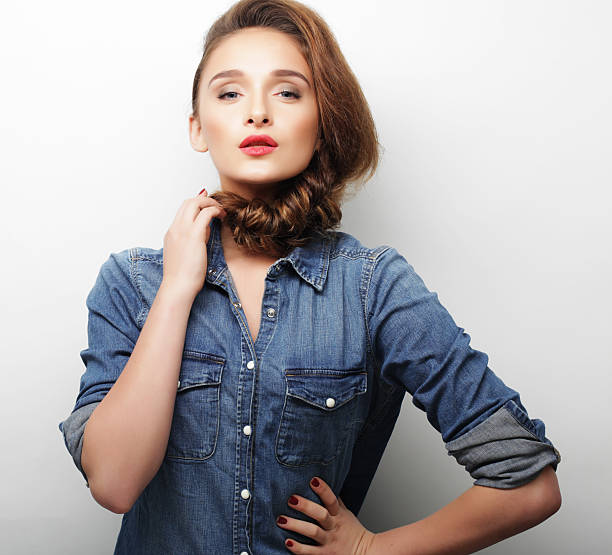 Young beautiful woman wearing casual clothes, posing on white background