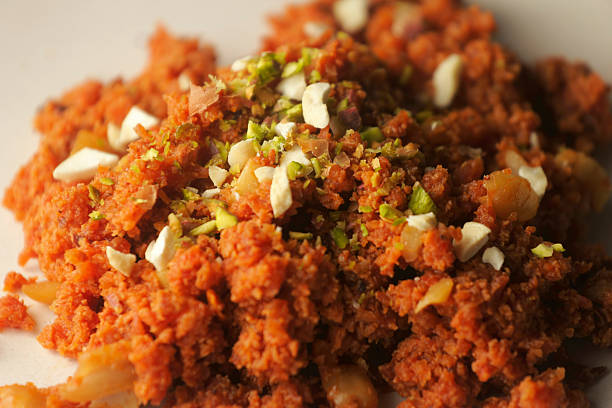 Detailed close-up of carrot halwa showing its soft texture, rich color, and chopped nut garnish.