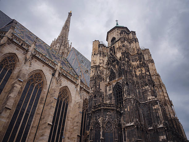 Summer view of Vienna Stephansplatz with iconic cathedral and surrounding old town streets, historic architecture, lively city atmosphere, European travel destination, cultural urban scene.