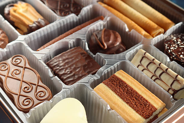 The silver foil and red wrapper are pulled back, revealing neatly arranged chocolate biscuit treats inside. Ideal for temptation concepts, quick snacks, and packaging design.
