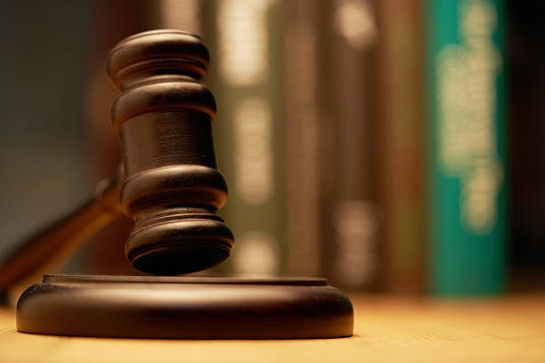 close up of gavel hammer against green background