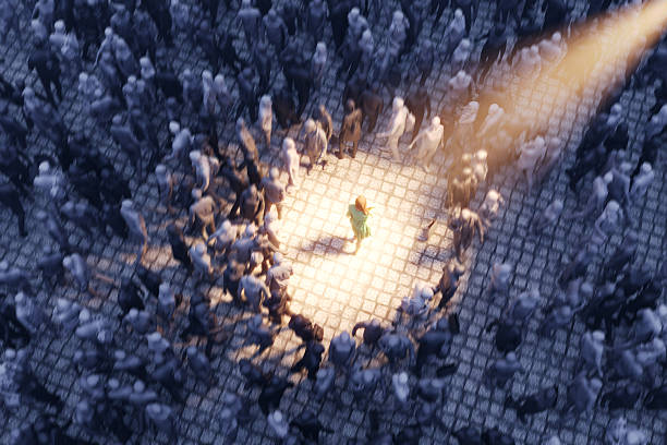 A single woman is illuminated by a warm spotlight while surrounded by a large monochrome crowd, symbolizing individuality, confidence, and standing out in modern urban life. Dramatic lighting and contrast emphasize personal identity within conformity. (3D render)