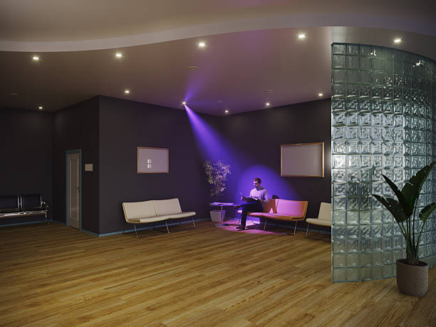 A single person sits quietly under a focused spotlight in a modern waiting room, symbolizing individuality, isolation, and introspection in everyday life. Soft lighting and minimal interior design emphasize emotional contrast and personal space. (3D render)