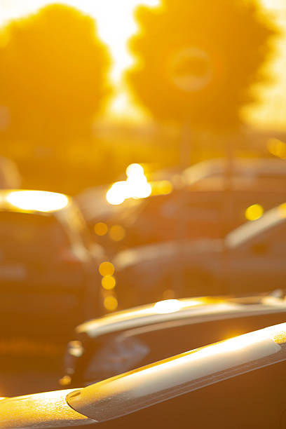 De-focused photo of a parking lot in sunset time.