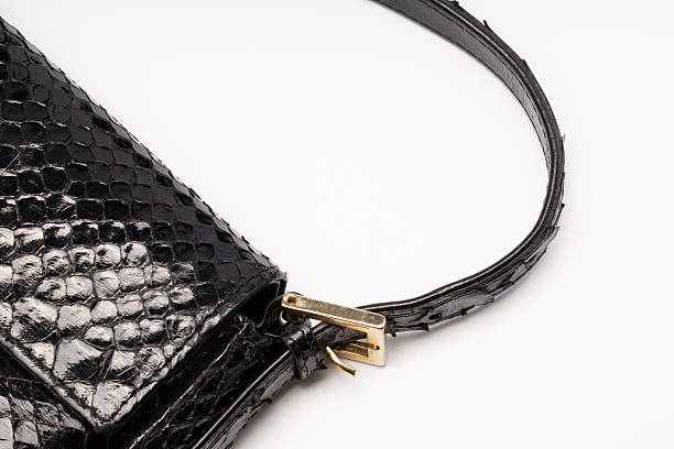A studio close-up and full view of a luxury black crocodile embossed leather shoulder bag featuring glossy reptile texture, silver chain strap, leather shoulder pad, and metal hardware details, photographed from multiple angles, isolated on a clean white background with copy space, suitable for fashion catalog, e-commerce, luxury accessories, and premium lifestyle concepts