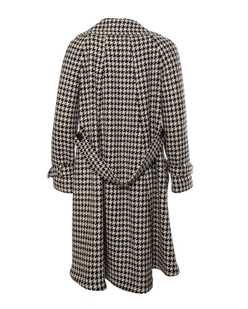 A vintage beige military style jacket featuring decorative cords and buttons isolated on a white background