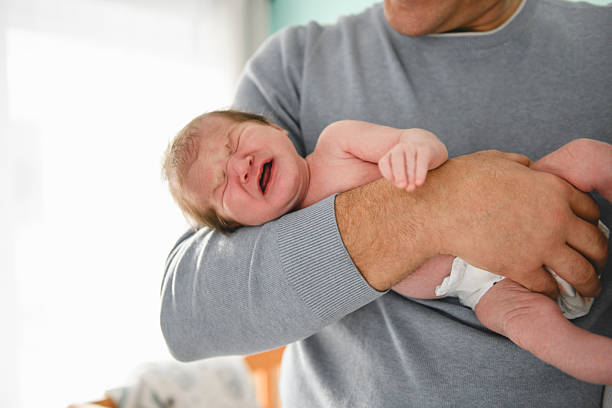 istock Father with his cute newborn baby indoors 2255394857