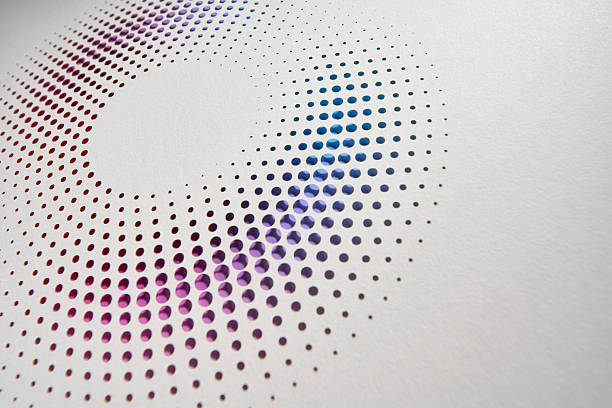 Still life photography of a perforated cut paper artwork featuring soft rainbow dots arranged in a radial circular pattern. Subtle gradients, clean white texture, and precise craftsmanship create a contemporary abstract design ideal for modern backgrounds and creative concepts.