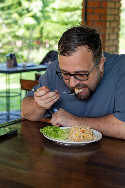 Man tasting traditional Thai cuisine fried rice with chicken