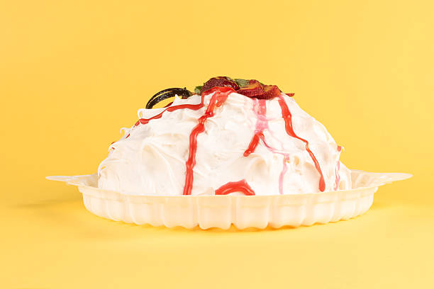 istock Whipped Cream Dessert with Fruit Toppings on Vibrant Yellow Background 2255400141