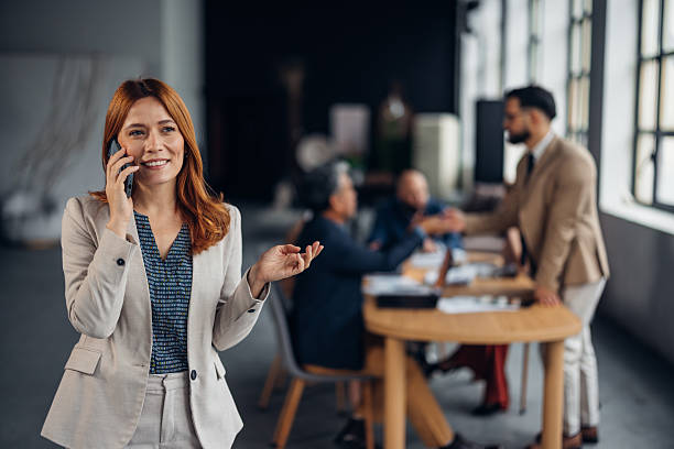istock Businesswoman with phone engaged in conversation 2255402626