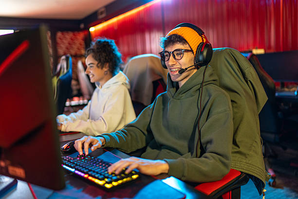 istock Young male gamer wearing headset playing video games 2255403528
