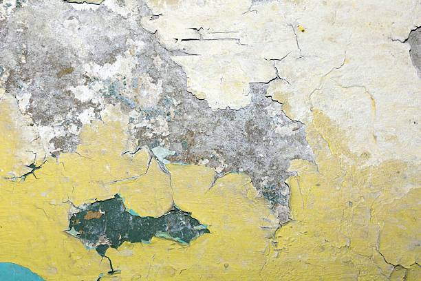 The crumbling plaster reveals layers of history and decay adding character to the building facade displaying a unique weathered appearance