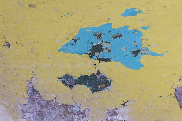 The image displays an aged surface exhibiting layers of worn pigment and structural damage, creating a unique visual pattern for backgrounds