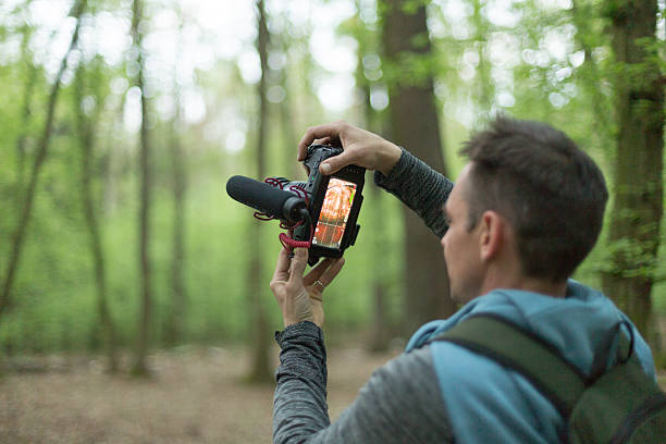 A photographer captures natures beauty in a vibrant green forest