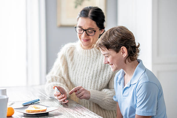 istock Smiling Couple At Kitchen Table Sharing a Moment While Looking at Phone and Toast Together 2255407429